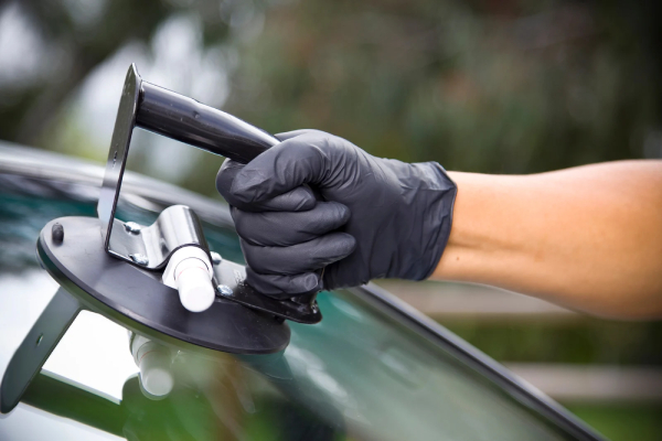 Glassco technician performing expert truck glass repair in Surrey, carefully fixing a damaged truck windshield with precision and quality materials.